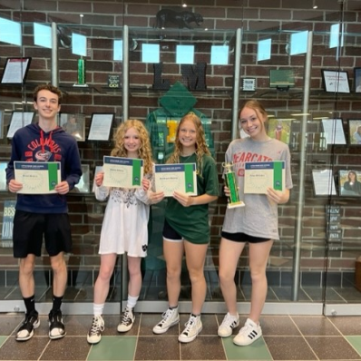 students smiling holding certificate