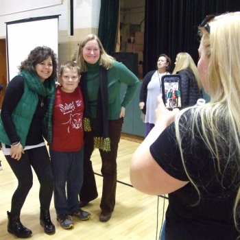 Photo of student with teachers