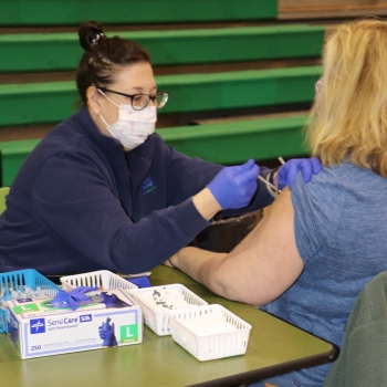 LM nurse administering COVID vaccine