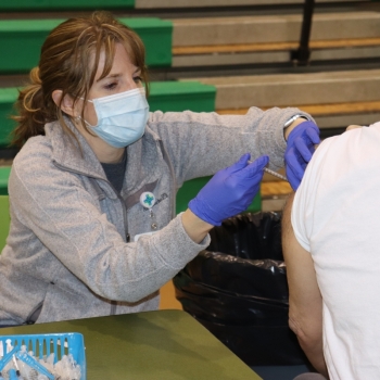 Nurse practitioner administers COVID vaccine