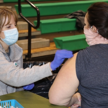 Nurse practitioner administers COVID vaccine