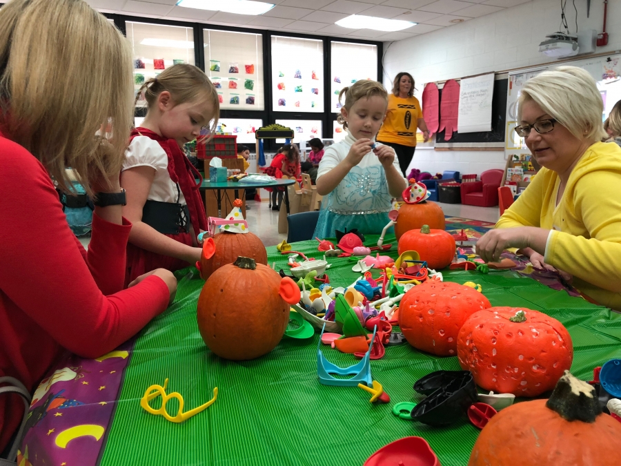 photo of student with pumpkins