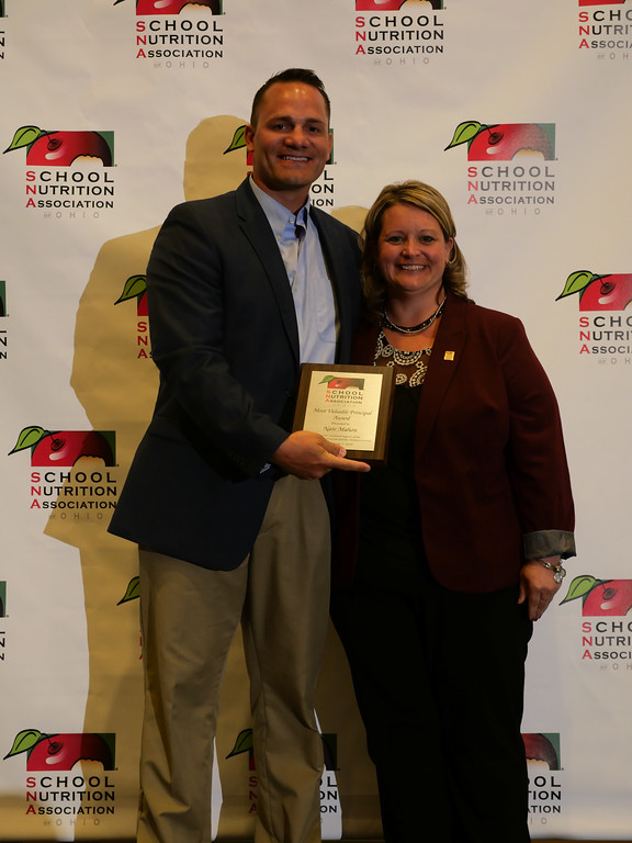 Photo of two people holding plaque