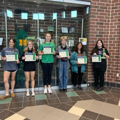 students smiling holding certificate