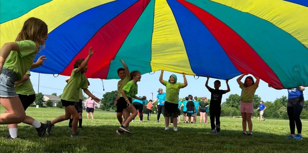 students under parachute at field day