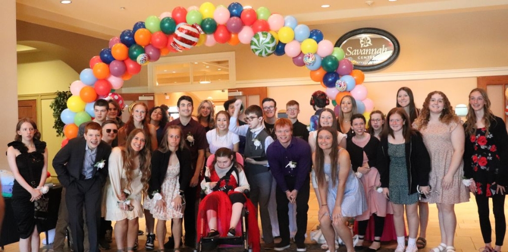 lmhs students smile under balloon arch at daylight prom